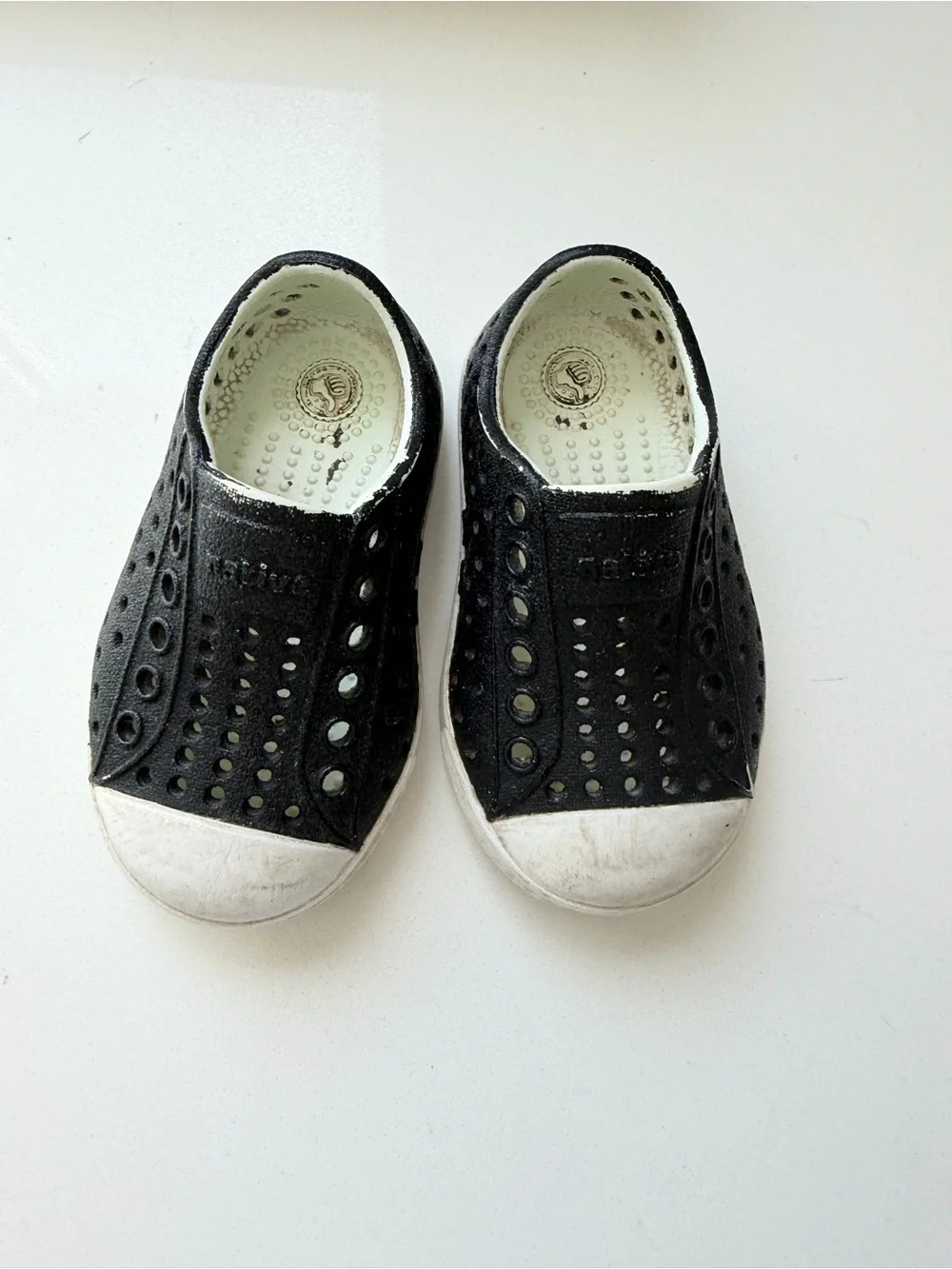 Native Kids Black Slip-On Water Shoes with White Soles and Teal Logo
